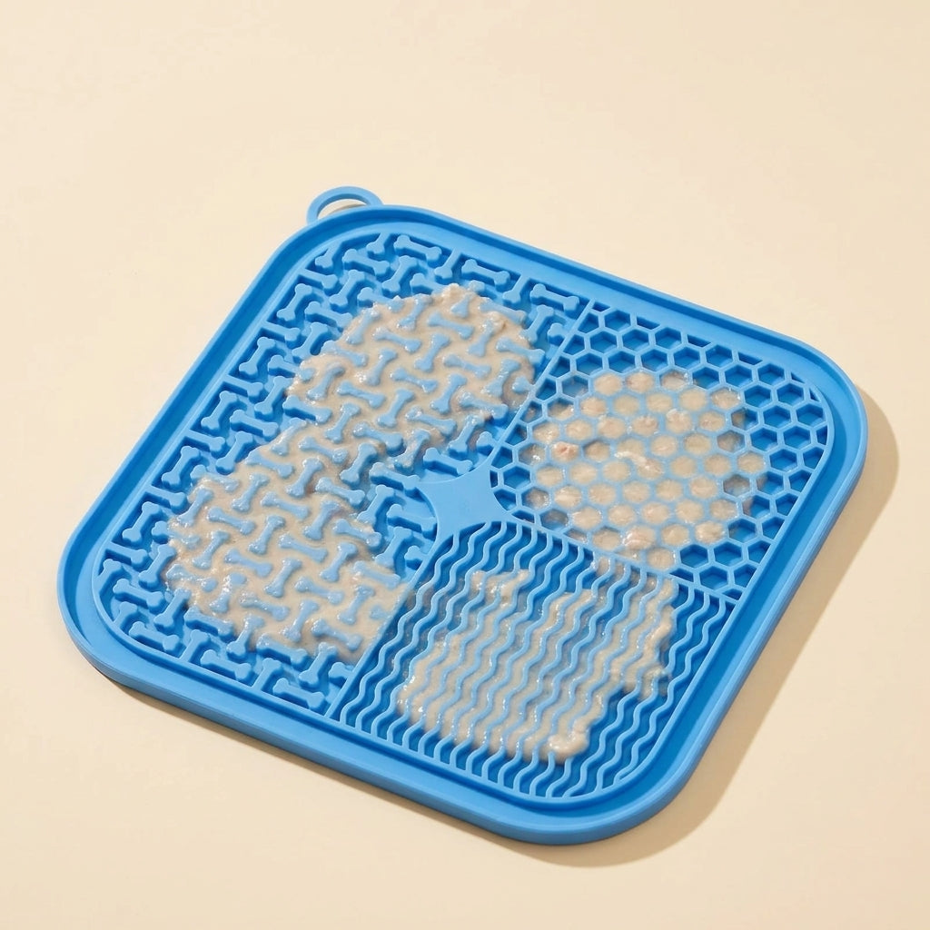 Blue silicone lick mat loaded with wet food next to a calm cat, showing slow feeding benefit