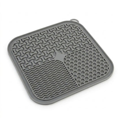 Clean studio product shot of a single grey CalmLick silicone slow-feeder lick mat